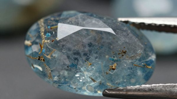 Polished blue beryl gemstone with translucent watery blue hue.