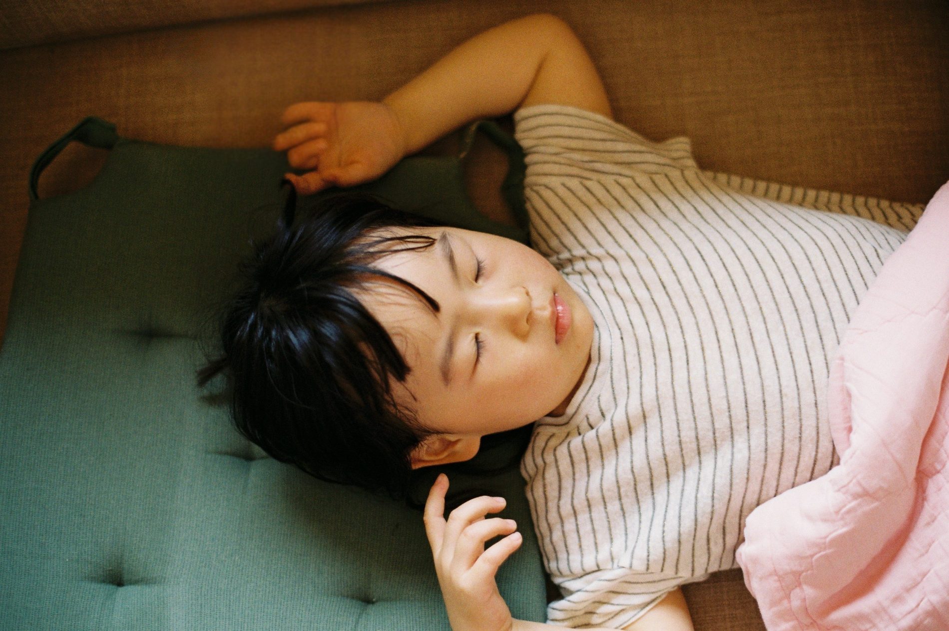 A child resting quietly, showing the calm that follows calming an overstimulated child.