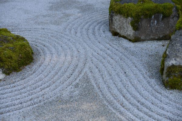 Minimal stone and sand garden representing rhythm, regulation, and the TCM view of health